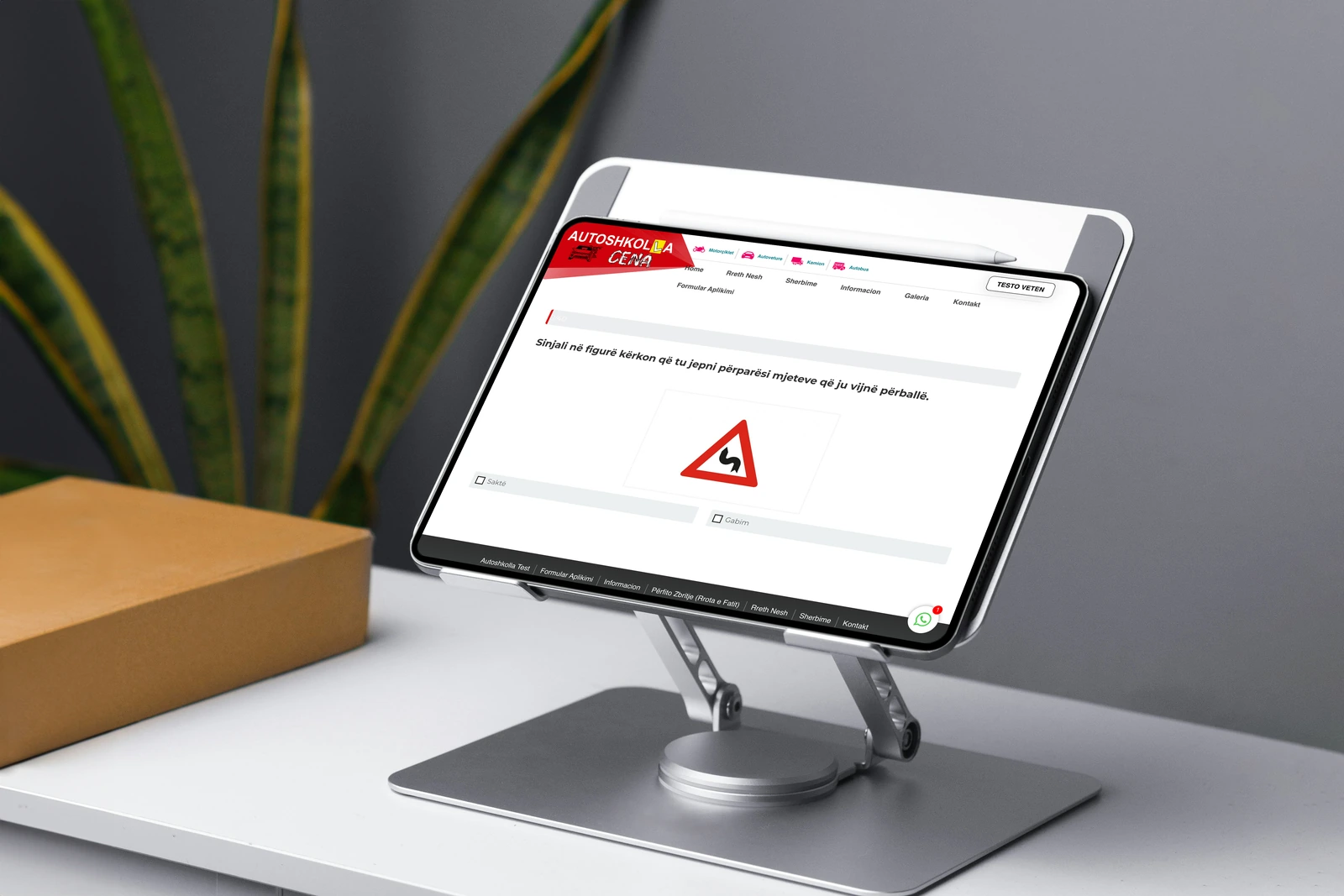 The unanswered car licence theory practice from Autoshkolla Cena displayed on a landscape tablet and stand.