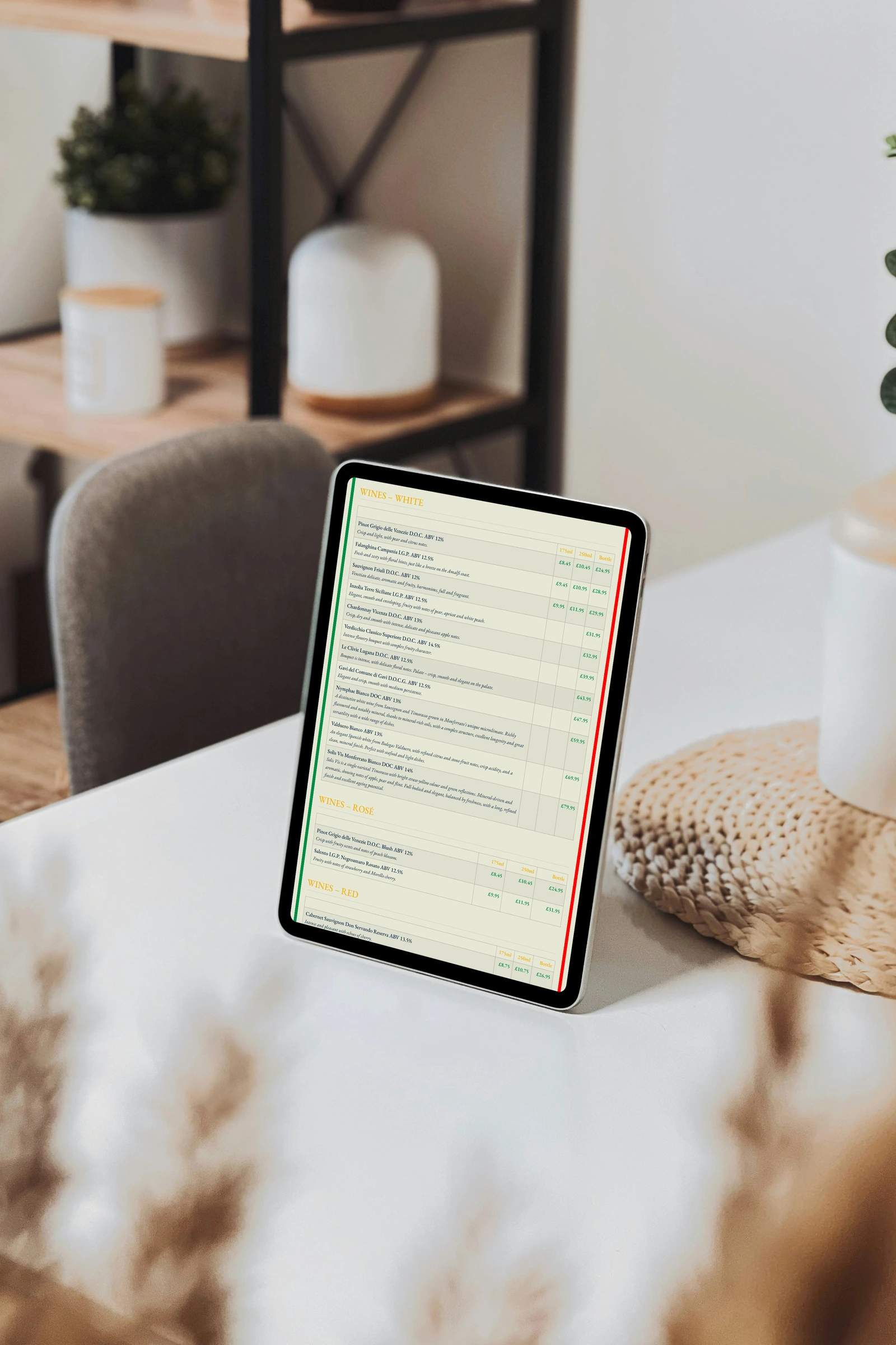 All eleven white-wine rows, descriptions and 175 ml, 250 ml and bottle columns on a tablet in a photographed setting.