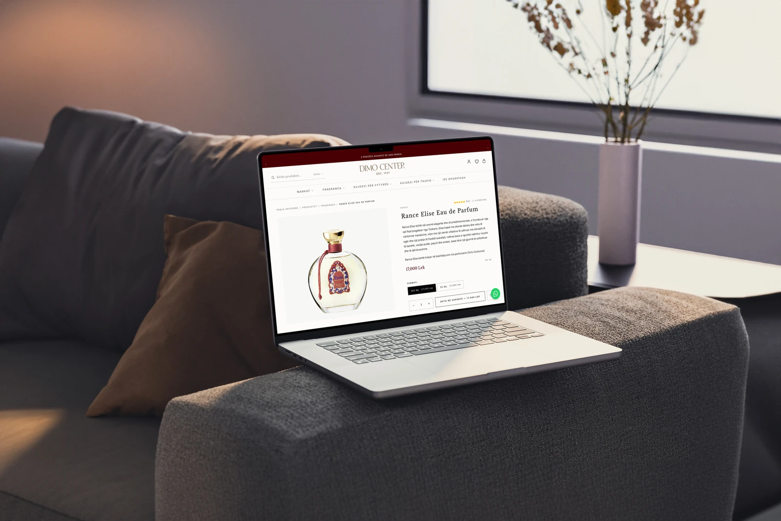 Dimo Center fragrance product page displayed on a MacBook in a photographed setting