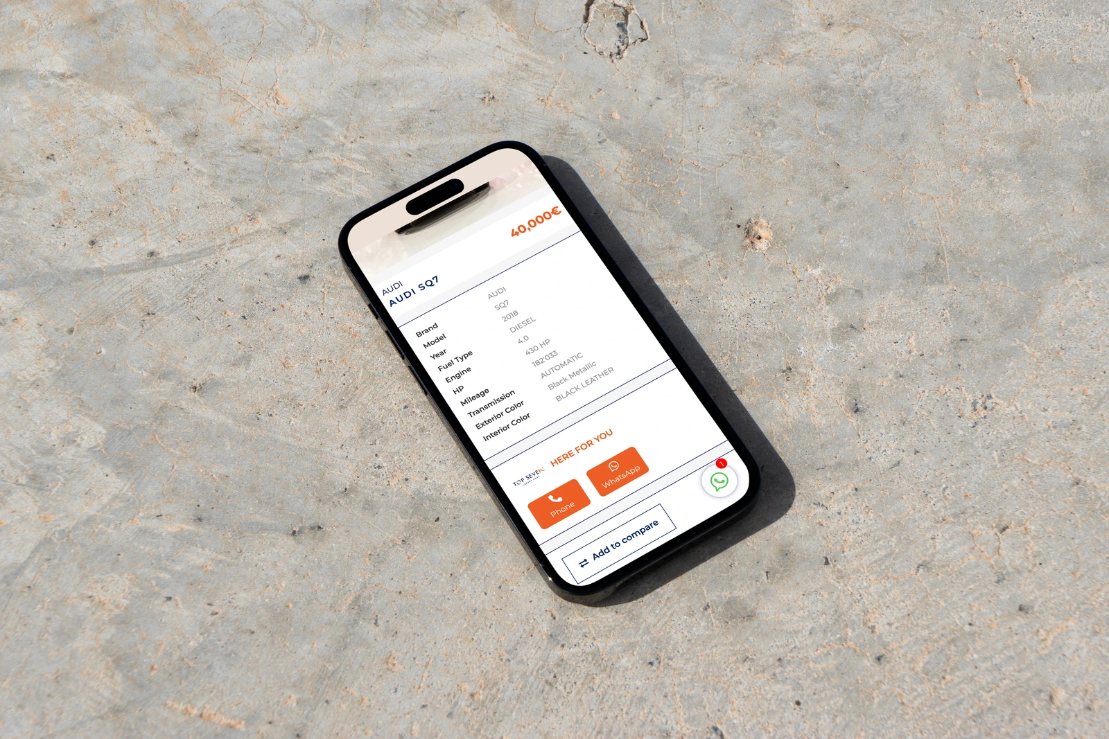 The Audi SQ7 vehicle information from Top Seven Luxury Cars displayed on a phone on a pale stone surface.