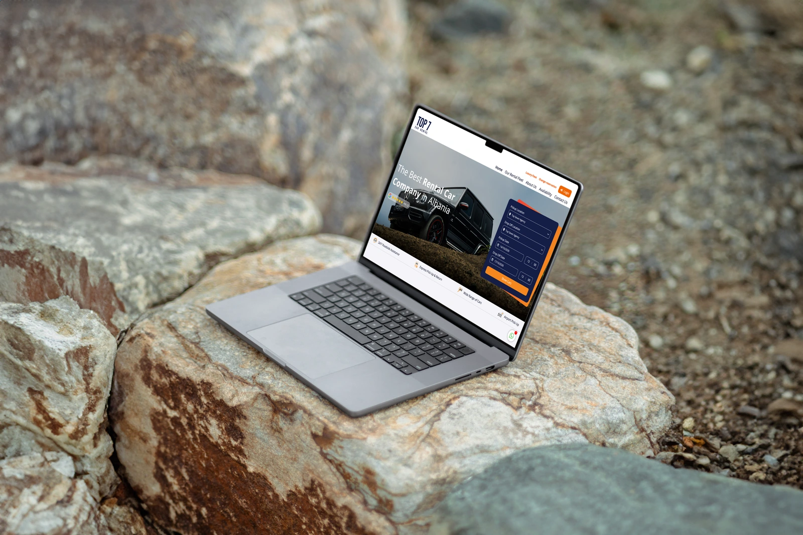 Top Seven Rental booking website on a MacBook on natural outdoor rocks.