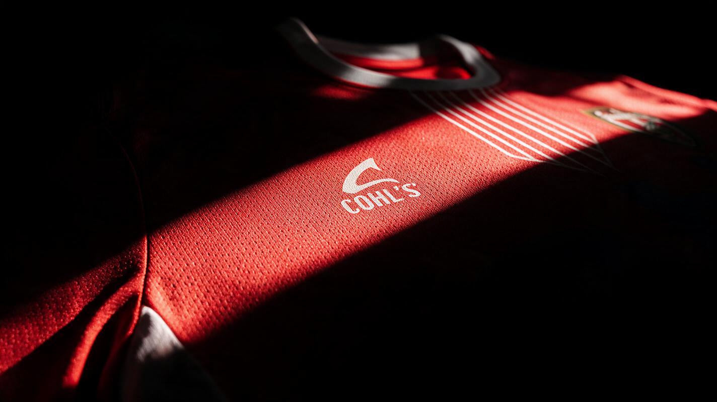 A close-up of the red club jersey and its fabric texture.