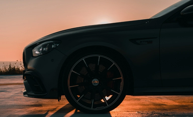 A dark Mercedes photographed in warm evening light, from the client website
